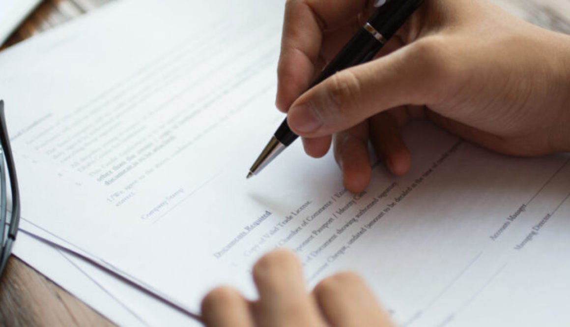 Businessman examining papers at table