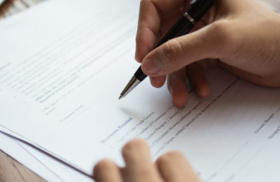 Businessman examining papers at table